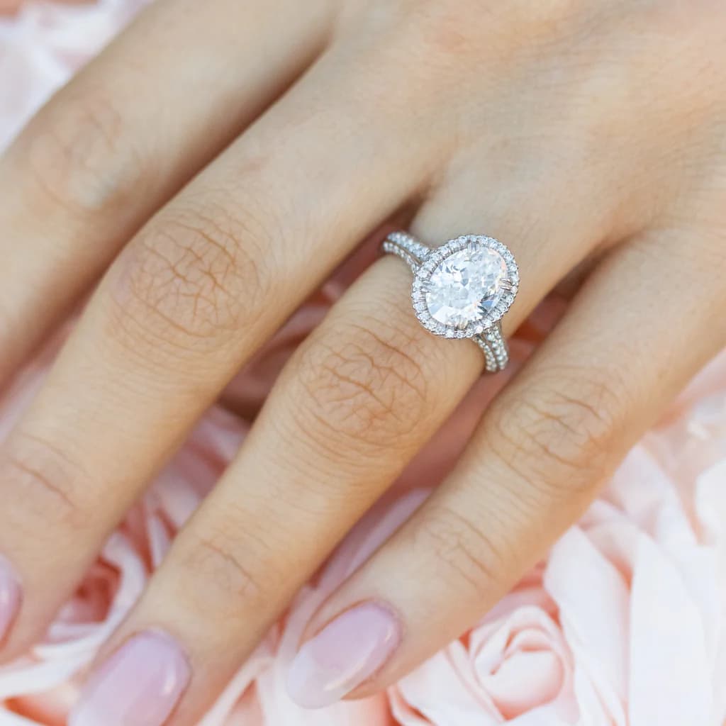 Oval diamond halo ring on hand created with the best AI jewelry design software