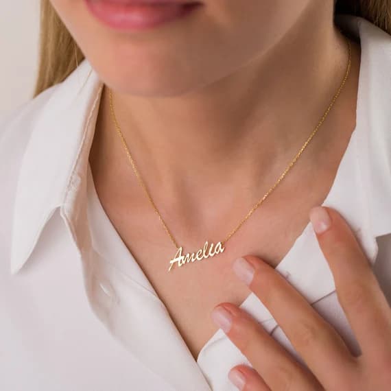 Woman wearing elegant gold script name necklace created with AI design tools